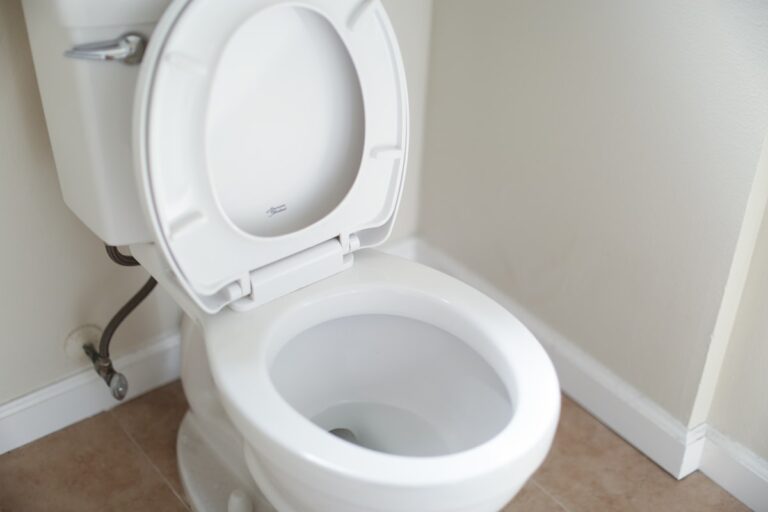 White ceramic toilet with tank lid, the type of toilet covered in this running-toilet repair guide
