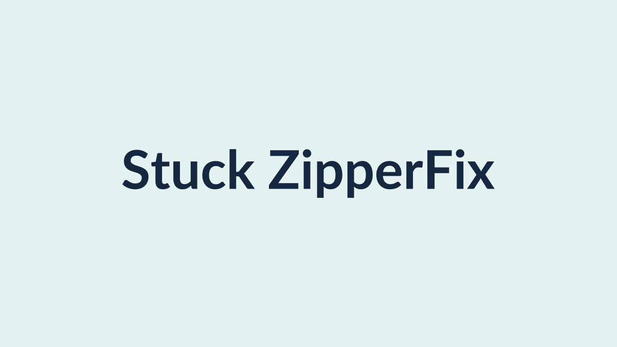 Using tweezers to free a stuck zipper jammed with fabric